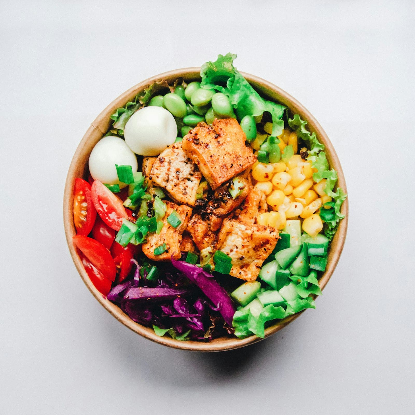 Colourful bowl of fresh vegetables, grains and greens